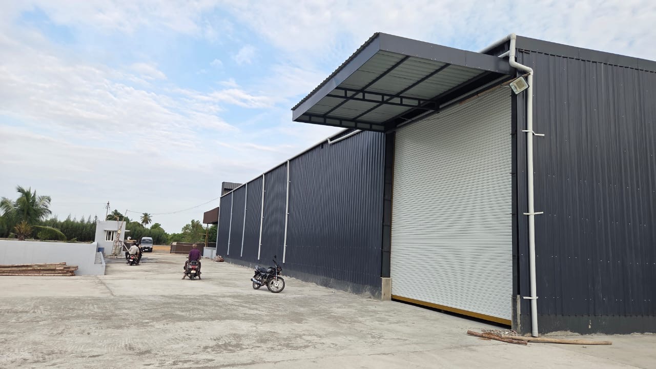 DAINA Machinery India warehouse side view with large roller shutter and access driveway